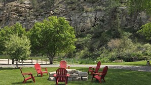 A grassy outdoor area with red Adirondack chairs and a stone fire pit. - Sheltered Nook Bunk 'n Board
Farm to Table experience  (Molt)
