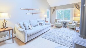 A living room with a sofa, armchairs, a fireplace, and a rug. - Official Seasons RMC Condo 11G - 2 bedrooms + loft - sleeps 10 - No Fees (Bartlett)
