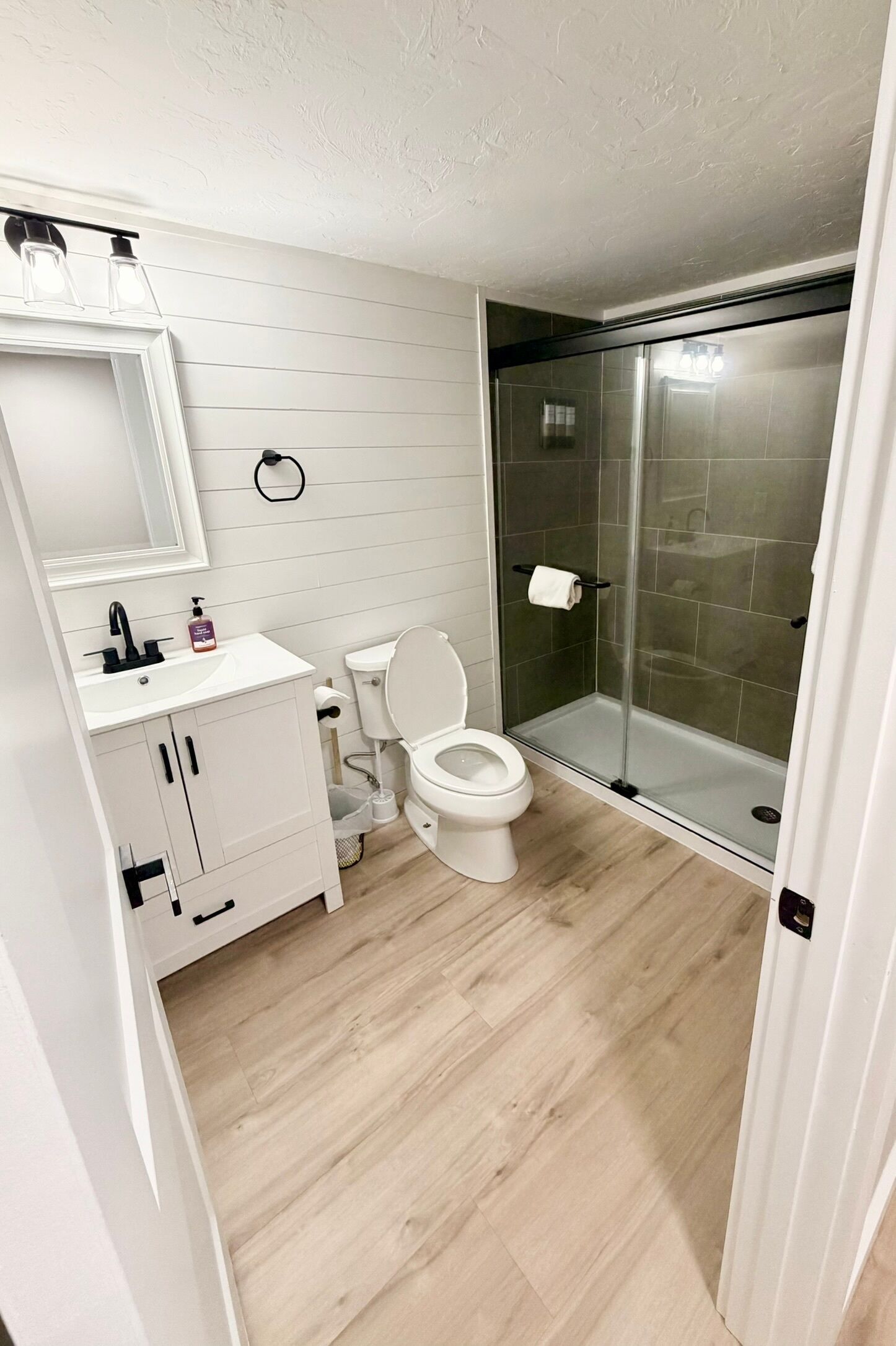 A modern bathroom with a toilet, sink, and shower area.