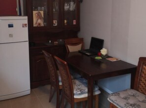 A compact dining area with a table and chairs, perfect for a workspace or study.