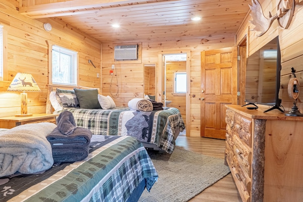 The first bedroom has two queen beds, complete with a TV for your entertainment