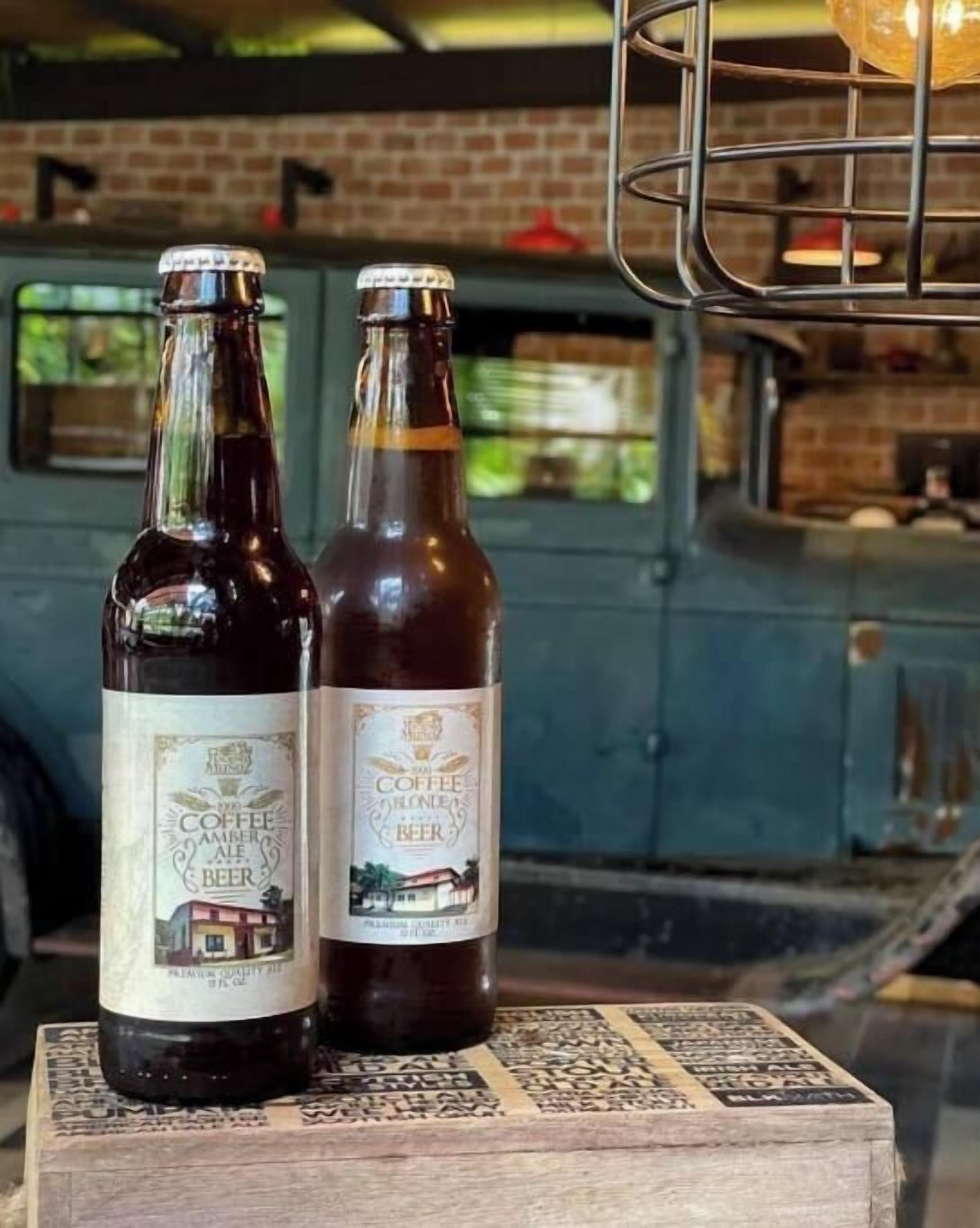 Two bottles of beer on a wooden block.
