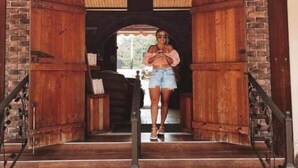 A staircase with wooden railings leading to an arched doorway. - The Sunset Shack (Ceiba)