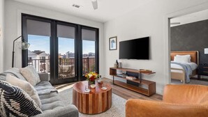 A modern living room with a sofa, coffee table, and TV.