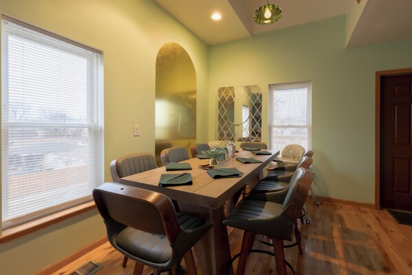 A conference room with a long table, chairs, and a large window.