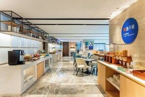 A modern breakfast area with a coffee machine, seating, and a sign for Express Breakfast. - Holiday Inn Express Hangzhou Huanglong by IHG (Hangzhou)