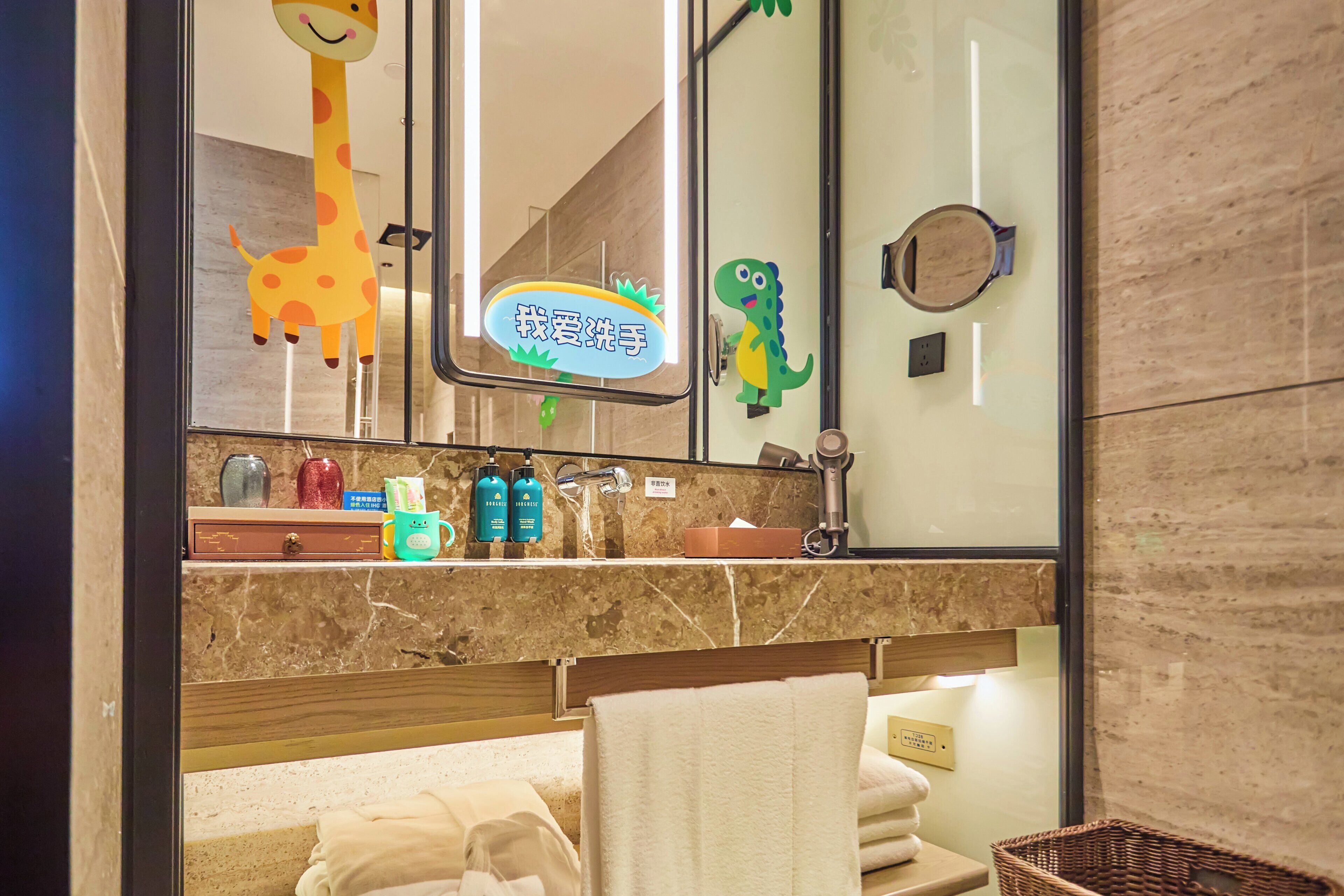 A bathroom with a mirror, a towel rack, and a sink with toiletries.
