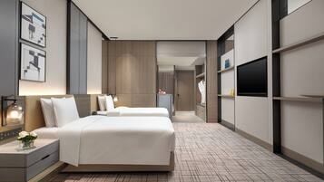 A modern hotel room with a large bed, bedside tables, a flat-screen TV, and a wardrobe.