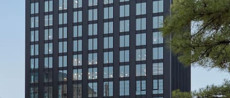 A modern building with a nameplate reading "CITIZEN".