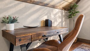 A rustic wooden desk with a plant, books, and a bowl. - Creek Haüs: Cozy Retreat w/ Endless Entertainment • HotTub • FirePit • GameRoom (Blue Ridge)