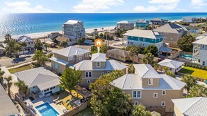 A coastal residential area with houses, a swimming pool, and a beach in the background. - C's The Day! Second to the beach, 3 Bed Plus loft (Panama City Beach)