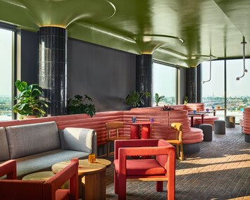 A chic indoor retreat with bold design elements, comfortable seating, and a relaxed ambiance—perfect for enjoying a meal or unwinding in style.