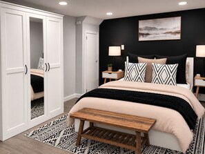 A bedroom with a bed, bedside tables, a nightstand, a bench, a wardrobe, and a painting on the wall. - Boutique Studio 10 min. walk to UBS Arena (Elmont)