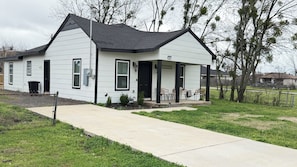 A single-story house with a front porch, a mailbox, and a number '603' sign.