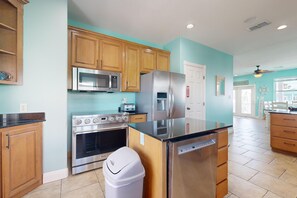 Enjoy cooking in this well-equipped kitchen with a refrigerator, microwave, oven, and dishwasher.