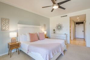 Relax in this serene bedroom with a large bed, nightstand, and dresser.