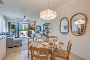 Enjoy meals in this spacious dining area with a round table, comfortable chairs, and a large mirror.