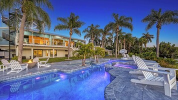 Pool and patio with poolside seating.