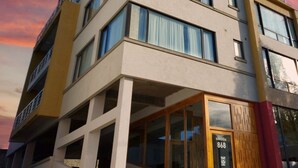 A multi-story building with a modern architectural design, featuring large windows and balconies. - MIRALEJOS APART HOTEL (Ushuaia)
