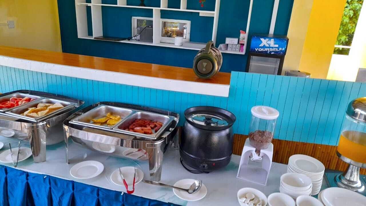 A buffet setup with various food items and serving utensils.
