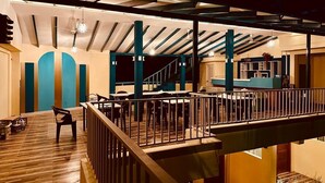 A multi-level outdoor dining area with wooden flooring, metal railings, and a staircase connecting the levels. - SORENZO Maldives  (Thoddoo)