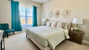 A bedroom with a bed, a nightstand, a chair, and a window with curtains. - Amazing home in Orlando just 5 minute away from Disney World (Kissimmee)