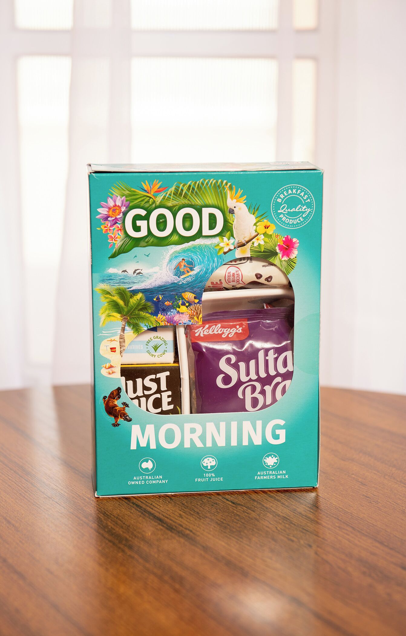A box of Good Just Ice Morning with a tropical design, including a parrot and flowers.
