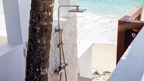 A beachside shower with a view of the ocean.