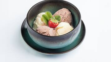 A bowl of ice cream with a strawberry garnish.