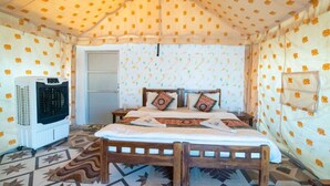 A room with a bed, a heater, and patterned walls. - ACE Desert Resort (Jaisalmer)