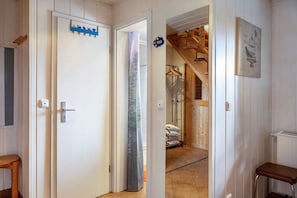 A room with a wooden ceiling, a door with a blue sign, a towel rack, and a framed picture on the wall. - Holiday Home 'Alwin' with Private Terrace and Wi-Fi (Goldlauter-Heidersbach)