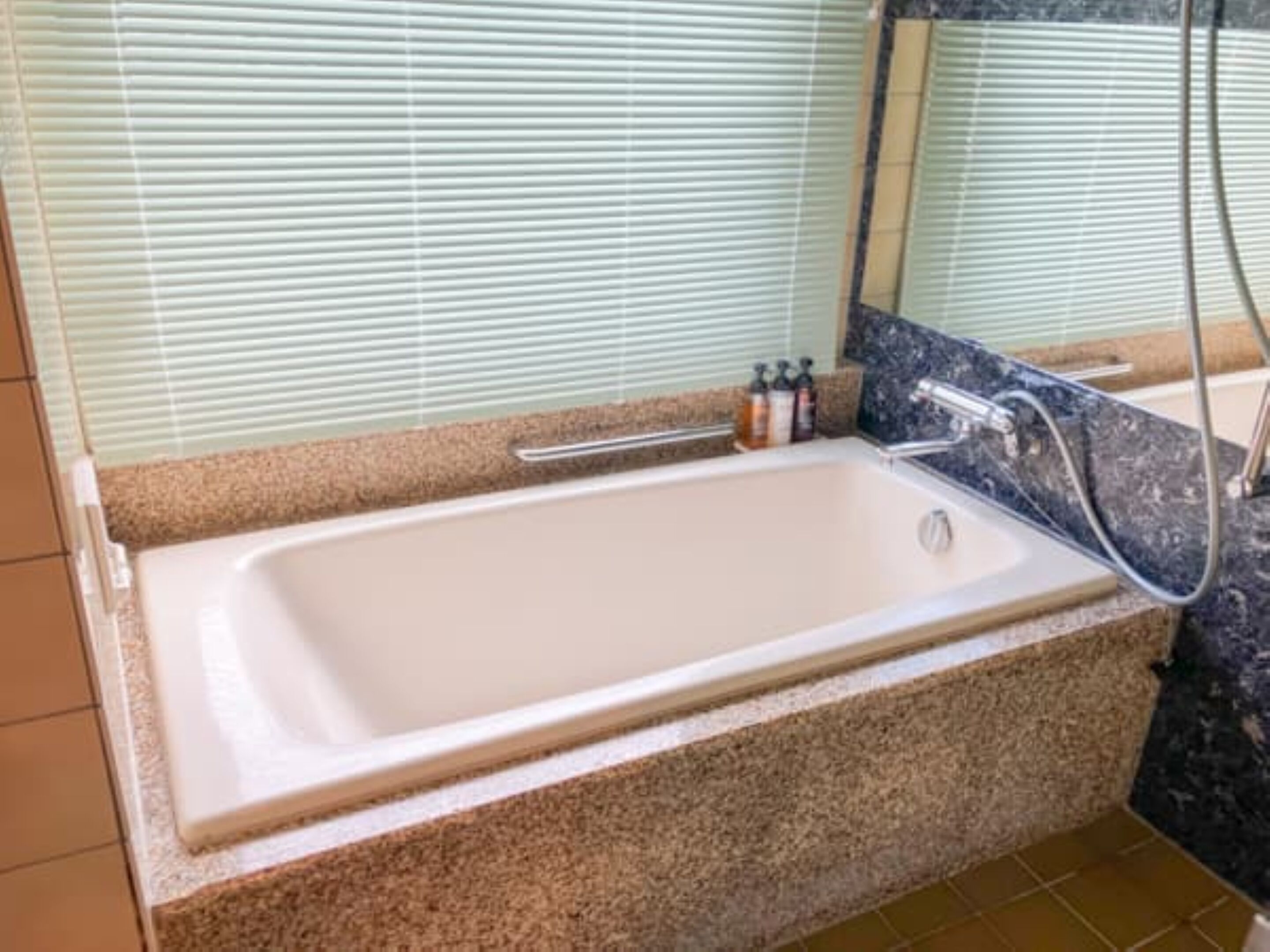 A bathroom with a bathtub, a shower, and a sink.