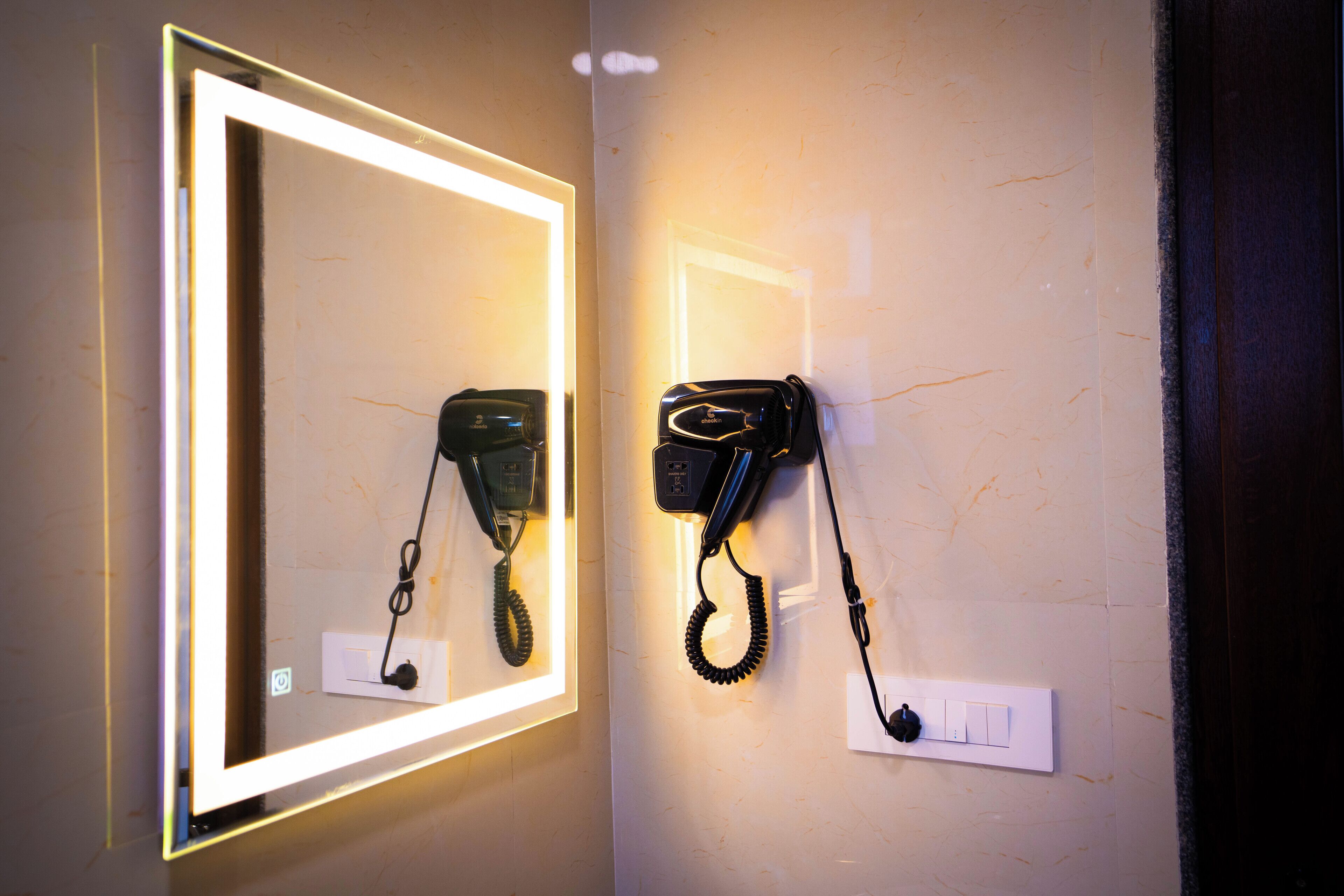 A wall-mounted telephone with a lighted frame and a separate handset.