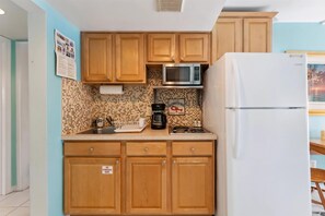 Fridge, microwave, coffee/tea maker, cookware/dishes/utensils