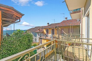 Ein Wohngebäude mit Balkon, Treppe und Blick aufs Meer.