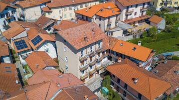 A densely packed residential area with multi-story buildings featuring red-tiled roofs and balconies.