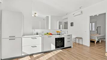 Family Apartment, 2 Bedrooms, Balcony, Mountainside (Quadrifoglio Stresa Hill with A/C and) | Private kitchen | Fridge, microwave, oven, stovetop
