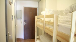 A room with a bunk bed, a wooden door, and a tiled floor. - Studio in Châtel near Portes du Soleil Ski Area (Châtel)