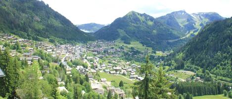 A mountainous village with houses spread across the valley.