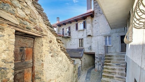A narrow stone staircase leading to a building with a wooden door and a balcony. - Bel Panorama 2 Ronco Sopra Ascona (Ronco sopra Ascona)