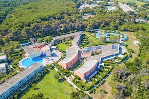 An aerial view of a resort with multiple buildings, a swimming pool, and surrounding greenery. - Villa 1 Sunset with Pool on Seashore (Otranto)