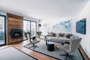 Comfort Apartment, City View | Living area | 65-inch Smart TV with cable channels