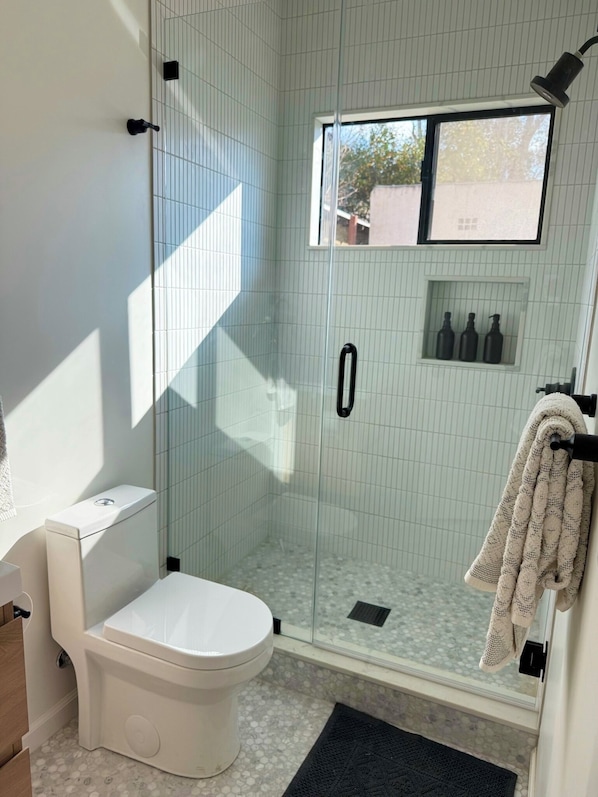 Shower, eco-friendly toiletries, hair dryer, towels