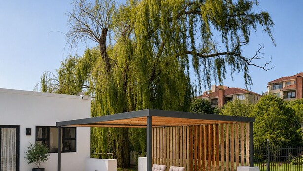 A modern outdoor pool area with a wooden pergola, lounge chairs, and a clear blue pool.