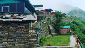 A traditional stone building with a steep stone staircase leading to a door. - Deodar Inn resort (Kalsi)