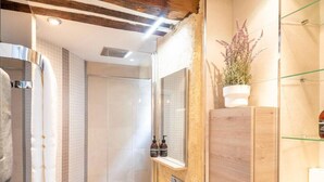 A modern bathroom with a glass shower enclosure, a wooden vanity with a mirror, and a potted plant. - #République#Paris2#Chatelêt#2bedrooms (Paris)