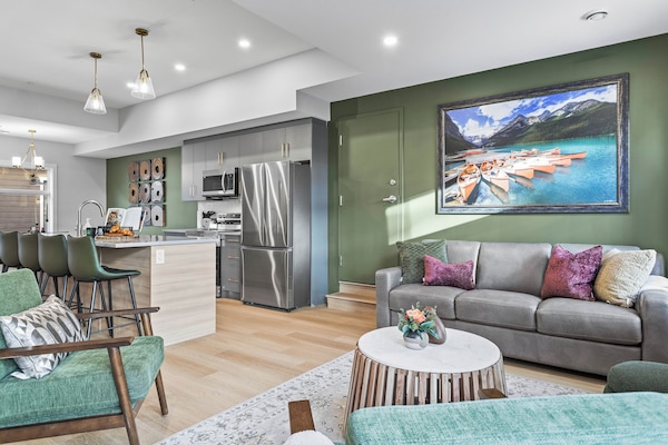 The living room features cozy seating, a warm fireplace, and a large smart TV for entertainment. With ample natural light and inviting decor, it's the perfect spot to relax, stream your favorite shows, or enjoy quality time with family and friends.