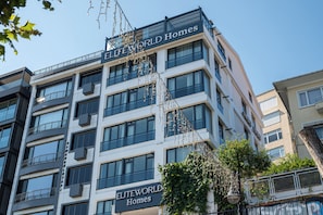 A multi-story building with balconies and large windows, labeled 'ELITEWORLD Homes'. - Elite World Homes Istanbul Bosphorus (Istanbul)