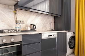 A modern kitchen with a built-in dishwasher, oven, and a washing machine. - Elite World Homes Istanbul Bosphorus (Istanbul)