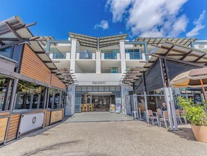 A modern building with a sign reading "PARADISO". - Luxury 3-bed oceanfront haven featuring a rooftop terrace with a private spa (Tweed)